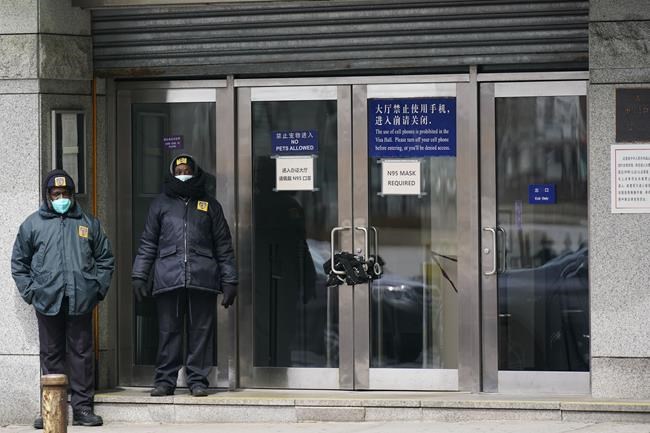 Guards stand outside of the Chinese consulate in New York, on March 28, 2022. Some of China's state media reporters are identifying as travel bloggers and lifestyle influencers on U.S.-owned social media platforms such as Instagram, Facebook and YouTube, racking up millions of followers from around the globe. The Associated Press has identified dozens of these accounts, which are part of a network of profiles that allow China to easily peddle propaganda to unsuspecting social media users. (AP Photo/Seth Wenig)