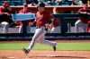 Arizona Diamondbacks' Daulton Varsho (12) arrives at home plate to score a run against the San Francisco Giants on a double hit by teammate David Peralta during the fifth inning of a spring training baseball game Wednesday, March 23, 2022, in Scottsdale, Ariz. (AP Photo/Ross D. Franklin)
