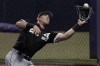 Chicago White Sox right fielder Andrew Vaughn catches a fly ball for the out on Seattle Mariners' Ty France during the first inning of a spring training baseball game Friday, March 25, 2022, in Peoria, Ariz. (AP Photo/Charlie Riedel)