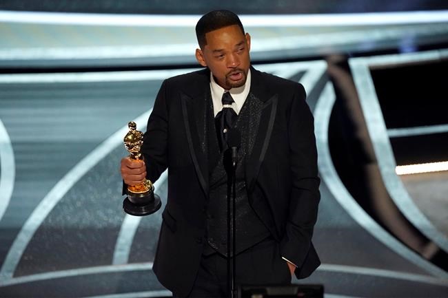 Will Smith cries as he accepts the award for best performance by an actor in a leading role for