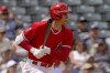 Los Angeles Angels' Shohei Ohtani follows through on a base hit against the Oakland Athletics during the first inning of a spring training baseball game, Monday, March 28, 2022, in Tempe, Ariz. (AP Photo/Matt York)