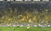 FILE - In this file photo, Borussia Dortmund's fans celebrate on the famous south tribune 'Gelbe Wand', the largest terrace for 24,454 standing spectators in European football, in the Signal Iduna Park stadium in Dortmund, Germany, April 13, 2019. (AP Photo/Martin Meissner,file)