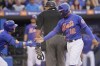New York Mets' Jeff McNeil, left, greets teammate Francisco Lindor after Lindor scored in the third inning of a spring training baseball game against the Miami Marlins, Thursday, March 24, 2022, in Port St. Lucie, Fla. (AP Photo/Sue Ogrocki)