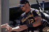 Milwaukee Brewers' Hunter Renfroe signs autographs before a spring training baseball game against the San Diego Padres Wednesday, March 30, 2022, in Peoria, Ariz. (AP Photo/Charlie Riedel)
