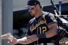 FILE - Milwaukee Brewers' Hunter Renfroe signs autographs before a spring training baseball game against the San Diego Padres, March 30, 2022, in Peoria, Ariz. Renfroe looks quite comfortable in his first spring training with the Brewers after he was acquired in a Dec. 1 trade with the Boston Red Sox. It helps that he was already very familiar with several of his new teammates long before the deal was completed. (AP Photo/Charlie Riedel)