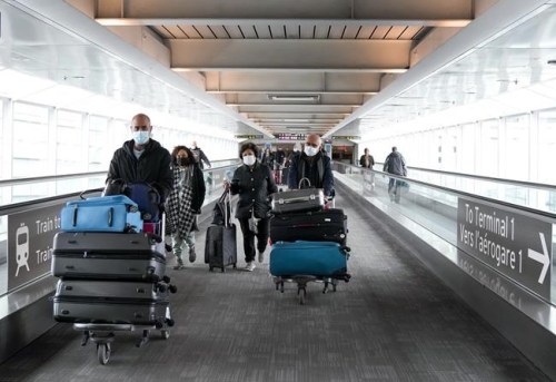 People travel at Pearson International Airport during the COVID-19 pandemic in Toronto, Friday, Dec. 3, 2021. Vaccinated travellers can enter Canada without doing a COVID-19 test, beginning today.THE CANADIAN PRESS/Nathan Denette