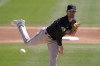 Cleveland Guardians starting pitcher Shane Bieber throws during the first inning of a spring training baseball game against the Los Angeles Dodgers Wednesday, March 23, 2022, in Glendale, Ariz. (AP Photo/Charlie Riedel)