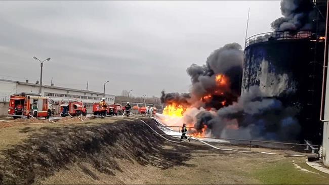 In this handout photo released by Russian Emergency Ministry Press Service on Friday, April 1, 2022, firefighters work at the site of fire at an oil depot in Belgorod region, Russia. The governor of the Russian border region of Belgorod accused Ukraine of flying helicopter gunships into Russian territory and striking an oil depot Friday morning. The depot is run by Russian energy giant Roseneft about 21 miles from the border. The governor says it was set ablaze by the attack that left two people injured. If confirmed, it would be the first attack of its kind by Ukrainian forces inside Russia. (Russian Emergency Ministry Press Service via AP)