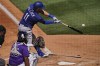 Los Angeles Dodgers' AJ Pollock (11) connects for a solo home run against the Colorado Rockies during the third inning of a spring training baseball gam,e Thursday, March 24, 2022, in Scottsdale, Ariz. (AP Photo/Matt York)