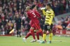Liverpool's Curtis Jones, right, leaves the field as his teammate Fabinho enters during the English Premier League soccer match between Liverpool and Watford at Anfield stadium in Liverpool, England, Saturday, April 2, 2022. (AP Photo/Jon Super)