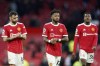 Manchester United's Bruno Fernandes, Fred and Anthony Elanga, from left, leave the field at the end of the English Premier League soccer match between Manchester United and Leicester City at Old Trafford in Manchester, England, Saturday, April 2, 2022. The game ended in a 1-1 draw. (AP Photo/Jon Super)