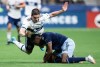 Vancouver Whitecaps Brian White, back left, and Sporting Kansas City's Nicolas Isimat-Mirin collide during the first half of an MLS soccer game in Vancouver, on Saturday, April 2, 2022. THE CANADIAN PRESS/Darryl Dyck