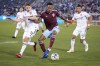 Colorado Rapids midfielder Mark-Anthony Kaye, center, fights for control of the ball as Real Salt Lake midfielders Scott Caldwell, left, and Maikel Chang defend during the first half of an MLS soccer match Saturday, April 2, 2022, in Commerce City, Colo. (AP Photo/David Zalubowski)