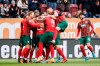 Augsburg players celebrate their opening goal during a German Bundesliga soccer match between FC Augsburg and VfL Wolfsburg in Augsburg, Germany, Sunday, April 3, 2022. (Matthias Balk/dpa via AP)
