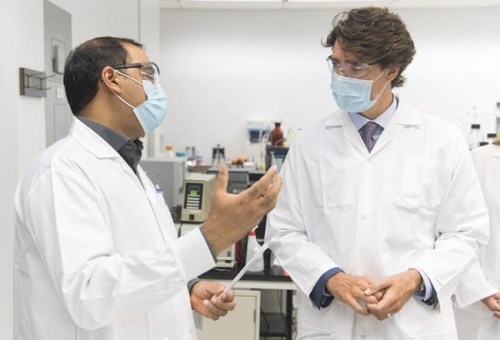 Prime Minister Justin Trudeau, right, speaks with scientist Krishnaraj Tiwari during a visit to the National Research Council of Canada (NRC) Royalmount Human Health Therapeutics Research Centre facility in Montreal, Monday, Aug 31, 2020. THE CANADIAN PRESS/Graham Hughes