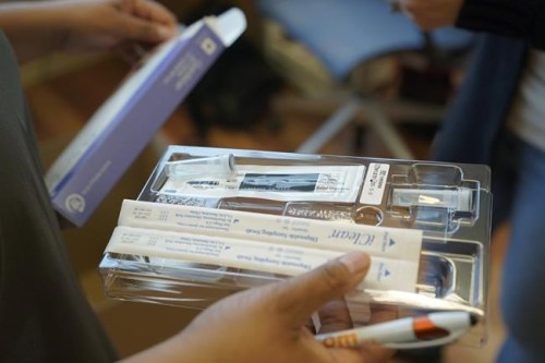FILE - A home COVID-19 test kit is held, Feb. 3, 2022, in Seattle. Medicare says that millions of enrollees will finally have access to free over-the-counter COVID-19 tests at drug stores. Monday's announcement comes amid worries that the latest coronavirus variant __ BA.2 __ will spark another rise in U.S. cases. (AP Photo/Ted S. Warren, File)
