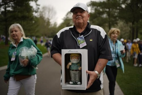 Dan Szatkowski, North Augusta, S.C, poses with his newly purchased garden gnome during a practice round for the Masters golf tournament on Tuesday, April 5, 2022, in Augusta, Ga. (AP Photo/Robert F. Bukaty)