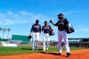 Cleveland Guardians' Jose Ramirez, right, talks with Amed Rosario, and Mike Sarbaugh, left, as they walk to the dugout before the team's spring training baseball game against the San Diego Padres on Tuesday, March 22, 2022, in Goodyear, Ariz. (AP Photo/Ross D. Franklin)