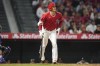 Los Angeles Angels' Shohei Ohtani (17) watches as his ball flies over the fence for a home run during the fifth inning of a spring training baseball game against the Los Angeles Dodgers in Anaheim, Calif., Sunday, April 3, 2022. (AP Photo/Ashley Landis)