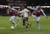 Everton's Alex Iwobi, front, controls the ball during the English Premier League soccer match between Burnley and Everton at Turf Moor, in Burnley, England, Wednesday April 6, 2022. (Richard Sellers/PA via AP)