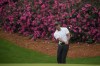 Tiger Woods chips to the green on the 13th hole during a practice round for the Masters golf tournament on Wednesday, April 6, 2022, in Augusta, Ga. (AP Photo/Charlie Riedel)