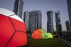 Domes featuring different national colors are displayed near the Doha Exhibition and Convention Center where soccer World Cup draw will be held, in Doha, Qatar, Thursday, March 31, 2022. The final draw will be held on April 1. (AP Photo/Darko Bandic)