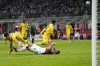 AC Milan's Olivier Giroud, on the ground, missing a chance for a goal by Bologna's Arthur Theate during the Serie A soccer match between AC Milan and Bologna at the San Siro stadium, in Milan, Italy, Monday, April 4, 2022. (AP Photo/Antonio Calanni)