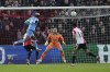 Slavia's Peter Olayinka, top left, heads the ball next to Feyenoord's goalkeeper Ofir Marciano, center, during the Europa Conference League quarter-final first leg soccer match between Feyenoord and Slavia Praha at De Kuip stadium in Rotterdam, Netherlands, Thursday, April 7, 2022. (AP Photo/Peter Dejong)