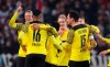 Dortmund's Julian Brandt, center, celebrates with his teammates after scoring during the German Bundesliga soccer match between Dortmund and VfB Stuttgart, at the Mercedes-Benz Arena in Stuttgart, Germany, Friday, April 8, 2022. (Tom Weller/dpa via AP)