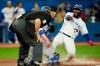 Toronto Blue Jays right fielder Teoscar Hernandez (37) looks at the home plate umpire slides into home plate during seventh inning American League baseball action against the Texas Rangers in Toronto, Friday, April 8, 2022. Hernandez was called out on the play but the video review overturned the call. THE CANADIAN PRESS/Frank Gunn