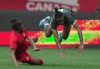 Nigeria's Grace Igboamalu, right, is upended by Canada's Kadeisha Buchanan during the first half of a women's friendly soccer match, in Vancouver, on Friday, April 8, 2022. THE CANADIAN PRESS/Darryl Dyck