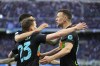 Inter Milan's Nicolo Barella, center, celebrates with his teammates Joaquin Correa, left, and Ivan Perisic after scoring his side's opening goal during the Serie A soccer match between Inter Milan and Hellas Verona at the San Siro Stadium, in Milan, Italy, Saturday, April 9, 2022. (AP Photo/Luca Bruno)