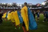 Players of Shakhtar Donetsk enter the pitch ahead of a friendly charity soccer match against Olympiakos at Karaiskaki stadium in Piraeus, near Athens, on Saturday, April 9, 2022. Ukrainian soccer club Shakhtar Donetsk will play a series of charity games on a government-backed “Global Tour for Peace” that will raise money for the country’s military in the war against Russia. The tour starts Saturday against Greek league leader Olympiakos. (AP Photo/Yorgos Karahalis)