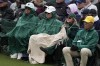 Bundled up against the cold spectators wait for play on the second green during the third round at the Masters golf tournament on Saturday, April 9, 2022, in Augusta, Ga. (AP Photo/Robert F. Bukaty)