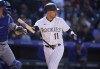 Colorado Rockies' Jose Iglesias reacts after striking out against Los Angeles Dodgers starting pitcher Walker Buehler in the fifth inning of a baseball game Friday, April 8, 2022, in Denver. (AP Photo/David Zalubowski)