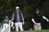 Scottie Scheffler, left, and Charl Schwartzel, of South Africa, wait to tee off on the 11th hole during the third round at the Masters golf tournament on Saturday, April 9, 2022, in Augusta, Ga. (AP Photo/Jae C. Hong)