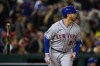 New York Mets' Pete Alonso flips his bat as he watches his grand slam against the Washington Nationals during the fifth inning of a baseball game at Nationals Park, Saturday, April 9, 2022, in Washington. (AP Photo/Alex Brandon)