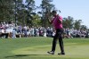 Tiger Woods acknowledges applause on the 18th green after finishing the first round at the Masters golf tournament on Thursday, April 7, 2022, in Augusta, Ga. (AP Photo/Robert F. Bukaty)