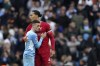 Liverpool's Virgil van Dijk, right, hugs Manchester City's Phil Foden at the end of the English Premier League soccer match between Manchester City and Liverpool, at the Etihad stadium in Manchester, England, Sunday, April 10, 2022. (AP Photo/Jon Super)