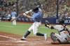 Tampa Bay Rays' Brandon Lowe connects on a two-run home run in front of Baltimore Orioles catcher Anthony Bemboom during the second inning of a baseball game, Sunday, April 10, 2022, in St. Petersburg, Fla. (AP Photo/Mike Carlson)