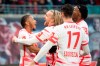 Leipzig's Christopher Nkunku, left, celebrates scoring with teammates during the Bundesliga soccer match between RB Leipzig and TSG 1899 Hoffenheim at Red Bull Arena in Leipzig, Germany, Sunday April 10, 2022. (Sebastian Kahnert/dpa via AP)