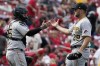 Pittsburgh Pirates starting pitcher Wil Crowe, right, and catcher Roberto Perez celebrate a 9-4 victory over the St. Louis Cardinals following a baseball game Sunday, April 10, 2022, in St. Louis. (AP Photo/Jeff Roberson)