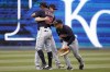 Cleveland Guardians' Oscar Mercado (35) Ernie Clement, center, and Steven Kwan, right, celebrate their team's 17-3 win over the Kansas City Royals at the end of a baseball game in Kansas City, Mo., Sunday, April. 10, 2022. (AP Photo/Colin E. Braley)