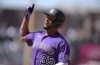 Colorado Rockies' Elias Diaz gestures to the dugout after hitting n RBI-single off Los Angeles Dodgers starting pitcher Julio Urias in the third inning of a baseball game Sunday, April 10, 2022, in Denver. (AP Photo/David Zalubowski)