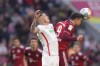 Augsburg's Jeffrey Gouweleeuw, left vies for the ball with Bayern's Robert Lewandowski during the German Bundesliga soccer match between Bayern Munich and Augsburg at the Allianz Arena, in Munich Germany, Saturday, April 9, 2022. (AP Photo/Matthias Schrader)