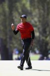 Tiger Woods reacts after his par putt on the third hole during the final round of the Masters golf tournament, Sunday, April 10, 2022, in Augusta, Ga. (Curtis Compton/Atlanta Journal-Constitution via AP)