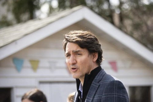 Prime Minister Justin Trudeau speaks about Budget 2022 highlights on housing investments from a podium in a family home's backyard in Hamilton, Ont., Friday, April 8, 2022. The federal budget this year placed a heavy emphasis on transitioning to the green economy, with new investments in critical minerals and metals, expanding the availability of zero-emission vehicles and charging stations. THE CANADIAN PRESS/Peter Power