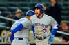 Toronto Blue Jays' George Springer, right, celebrates with third base coach Luis Rivera as he runs the bases after hitting a two-run home run during the third inning of a baseball game against the New York Yankees, Monday, April 11, 2022, in New York. (AP Photo/Frank Franklin II)