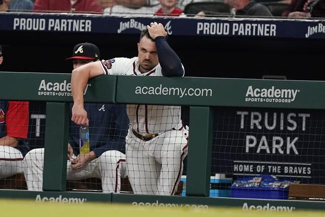 Atlanta Braves outfielder Adam Duvall watches from the dugout during a baseball game against the Washington Nationals, Monday, April 11, 2022, in Atlanta. (AP Photo/John Bazemore)