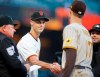 San Francisco Giants' Tyler Rogers (71) shakes hands with his brother San Diego Padres' Taylor Rogers (17) as they exchange lineups before their game in San Francisco, on Monday, April 11, 2022. (Nhat V. Meyer/Bay Area News Group via AP)